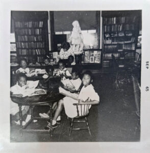 A group of schoolgirls reading together, dated Sept 1965.